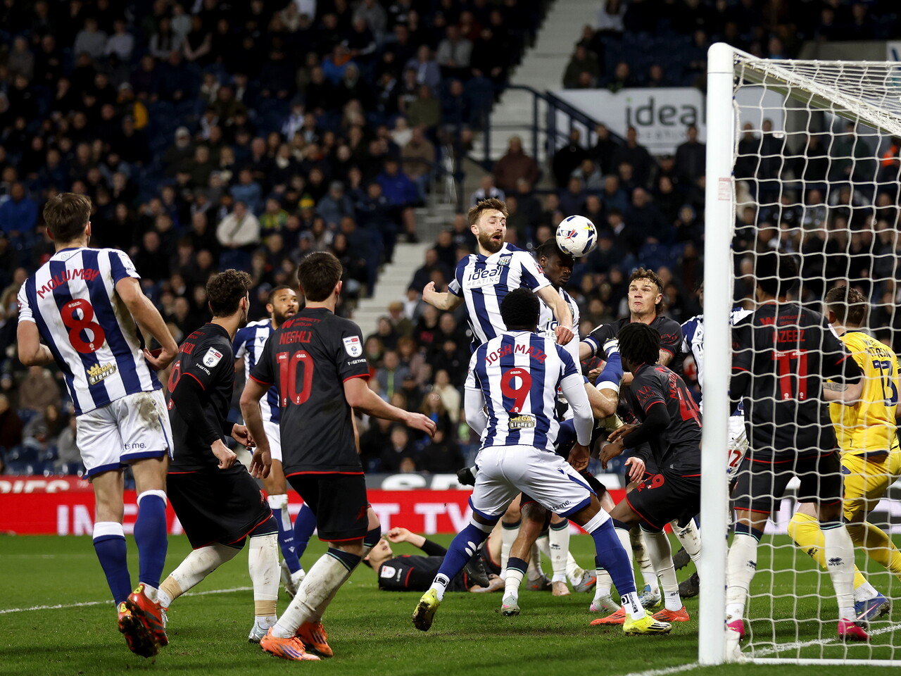 Several players jumping to win a header in the box against Millwall