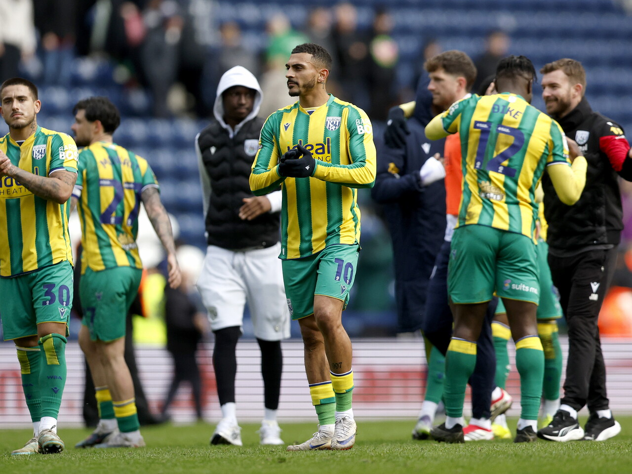Karlan Grant applauds the fans at full-time