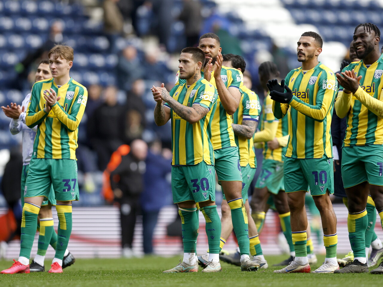 Danny Imray applauds the fans at full-time