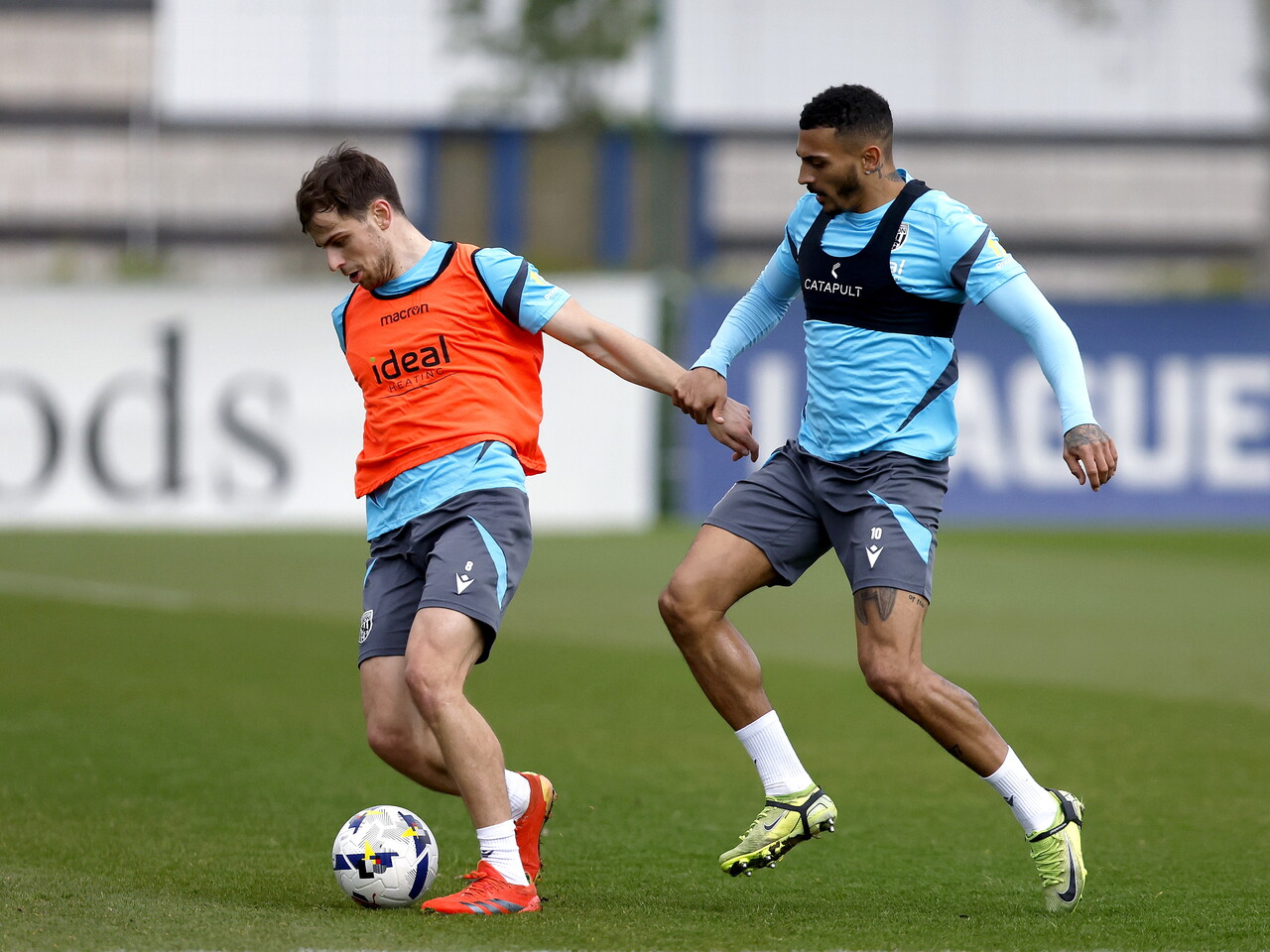 Jayson Molumby on the ball during training with Karlan Grant behind him