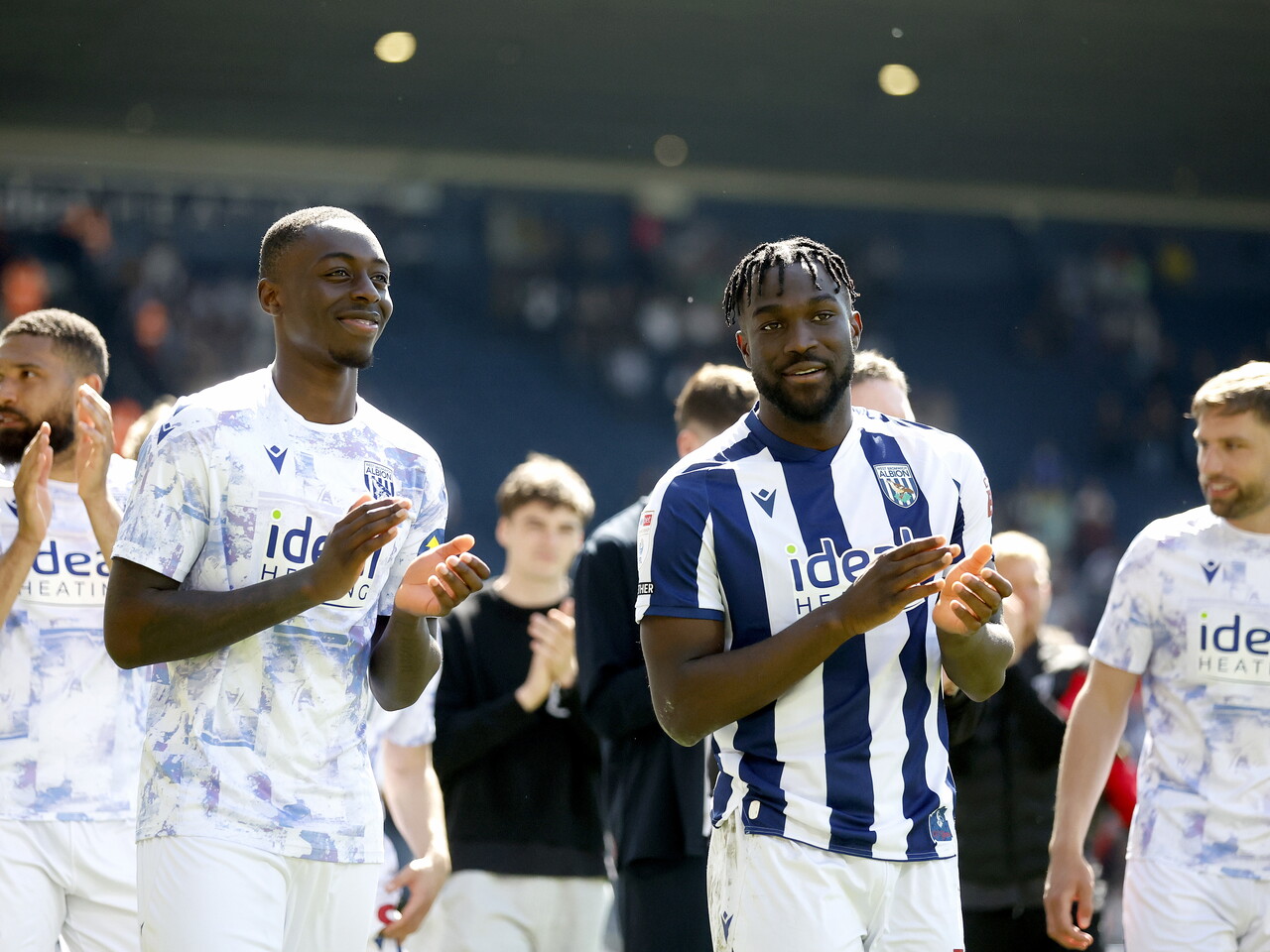 Eseosa Sule and Daryl Dike applaud WBA fans after the Ipswich game