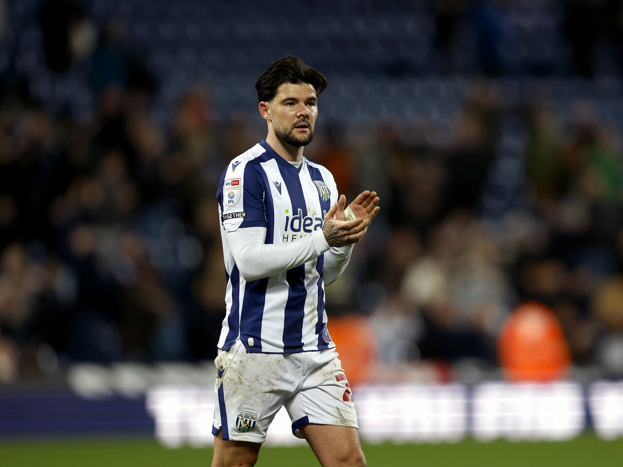 Alex Mowatt applauds the fans at full-time