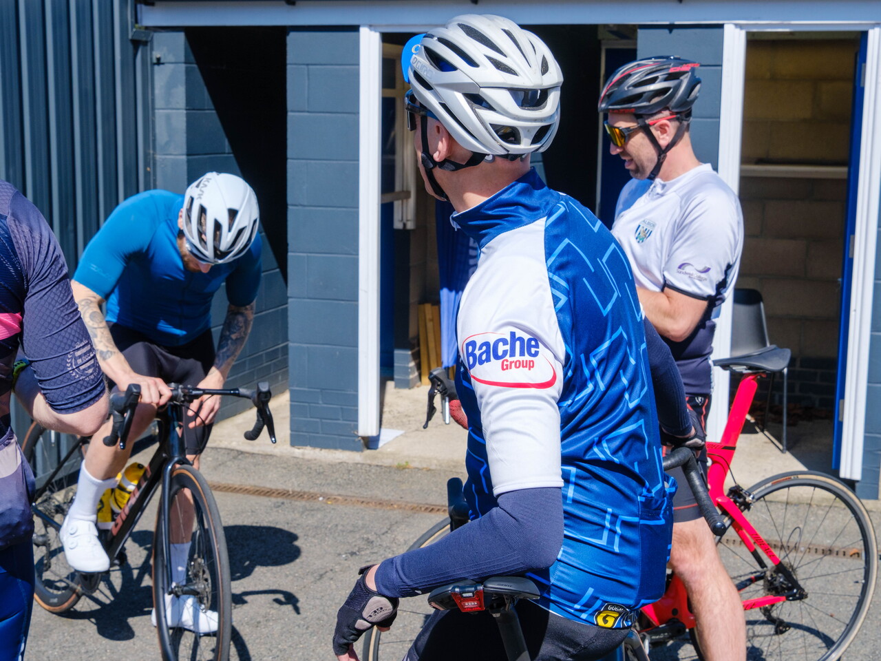 Cyclists relaxing before starting the first leg.