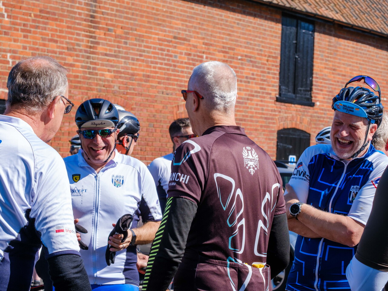 Cyclists laughing at a meeting stop.