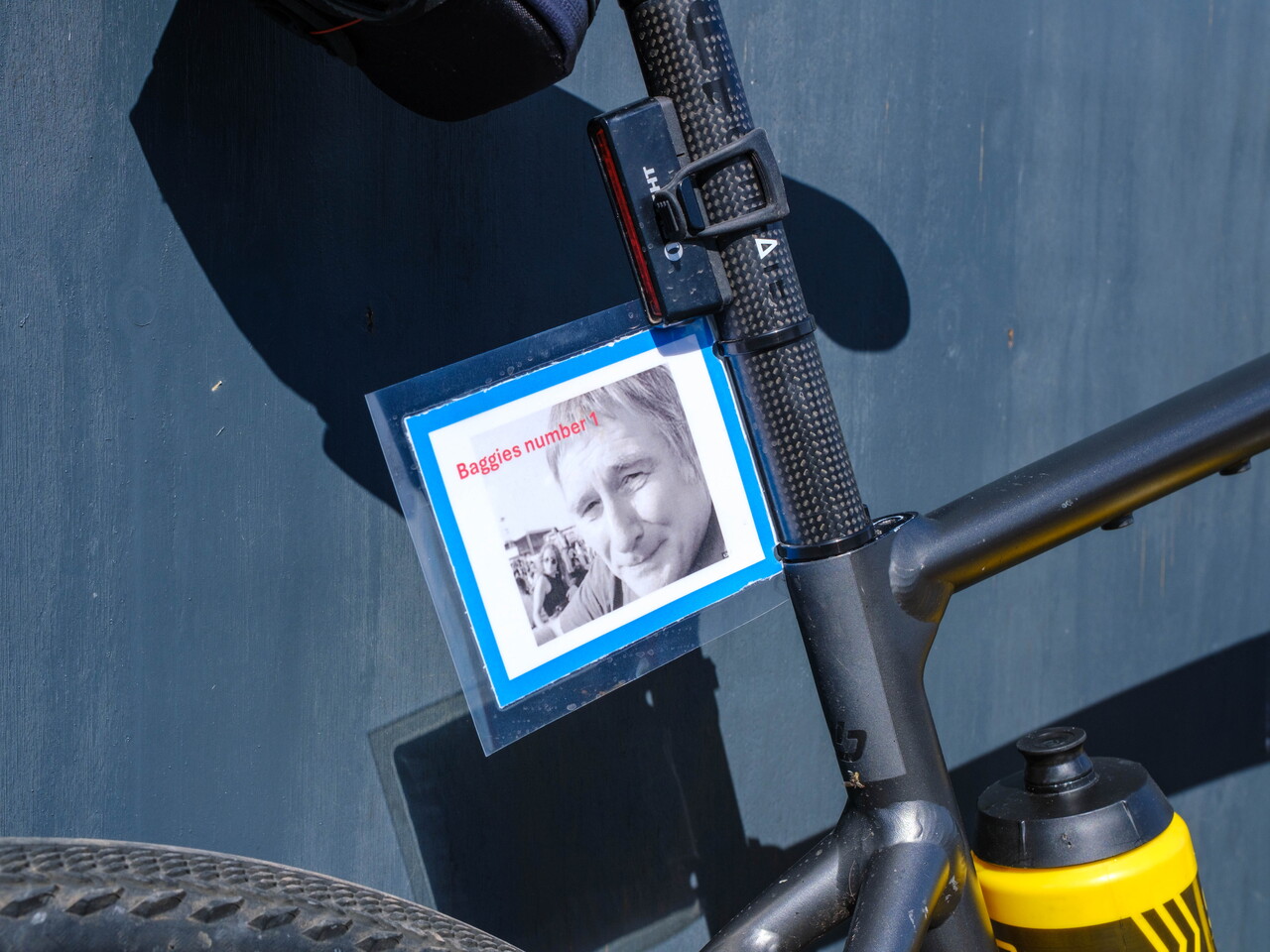 Close of cyclist's bike with tribute photo of Mark Townsend