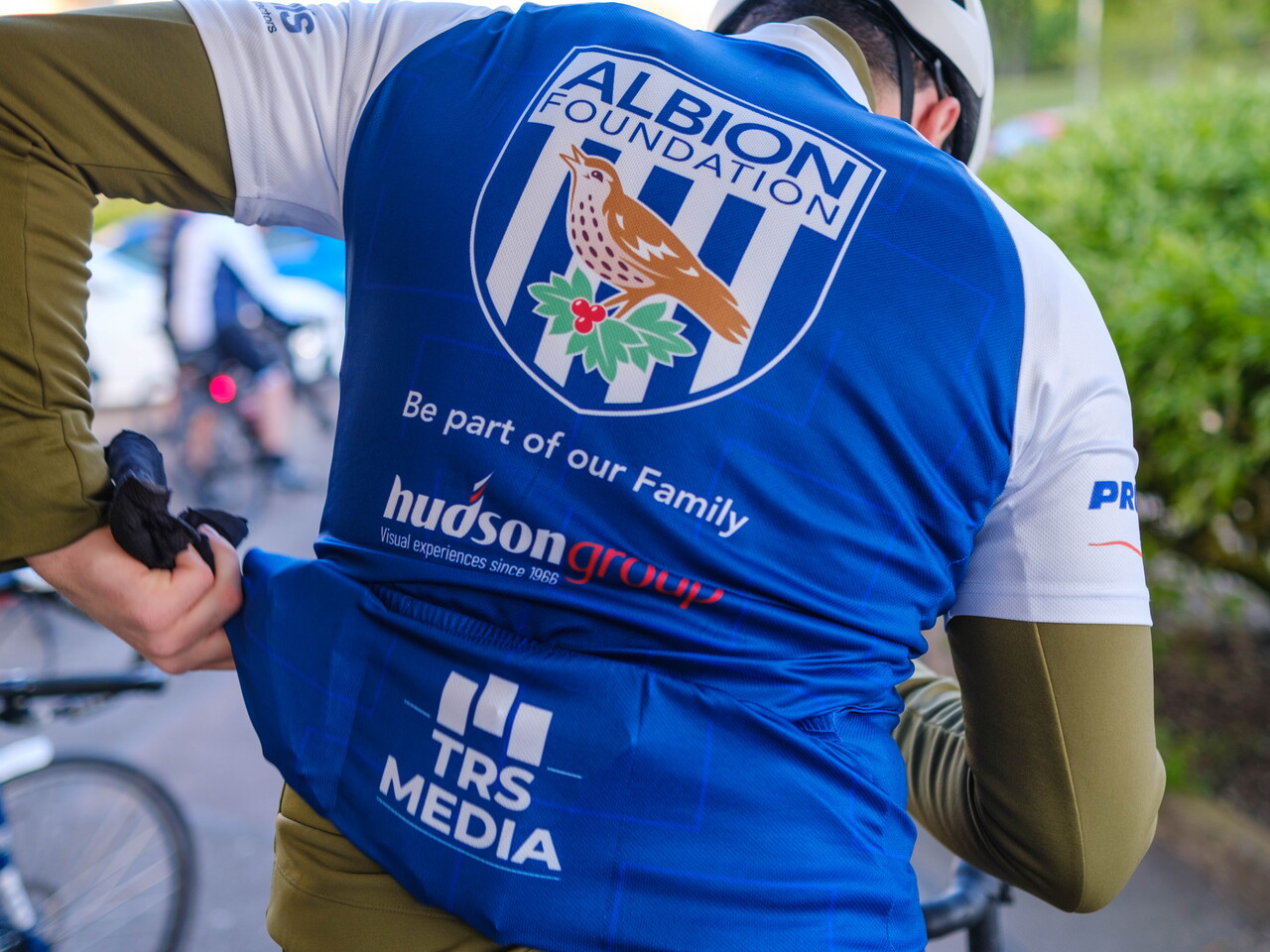 Reverse of cyclist jersey with Foundation badge, Hudson Group & TRS media on display.