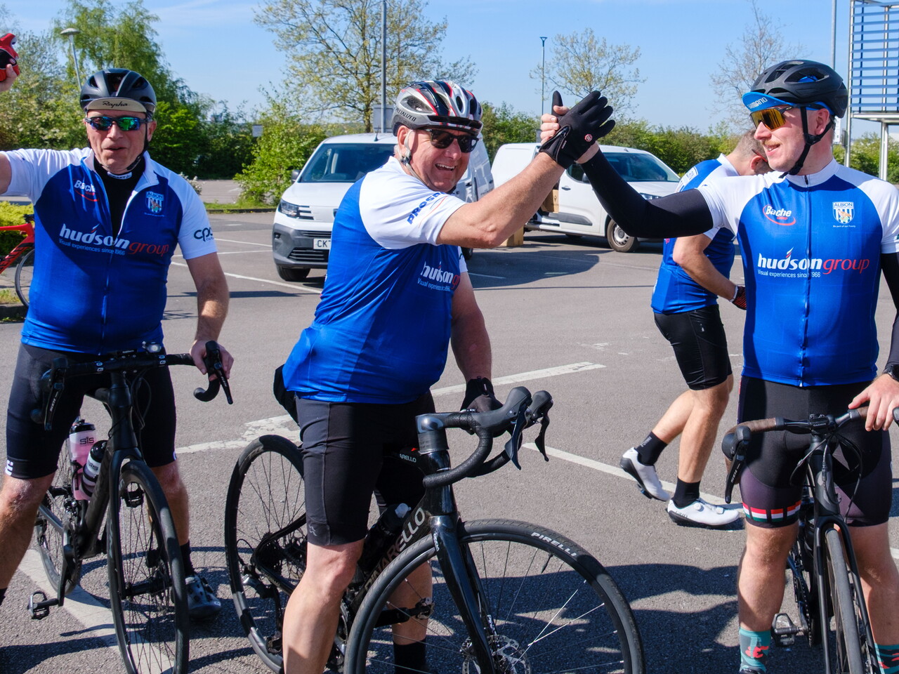 Cyclist shakes hands in delight.