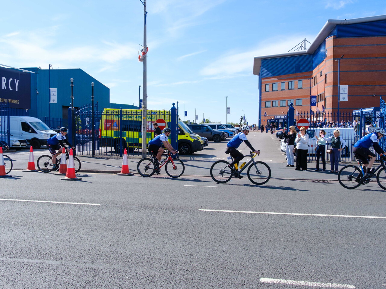 Cyclist riding place the gates of the East Stand.