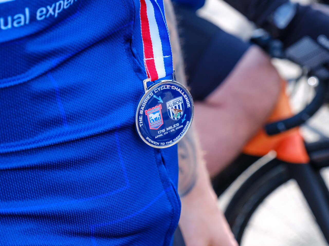 Close-up of cyclist's medal.