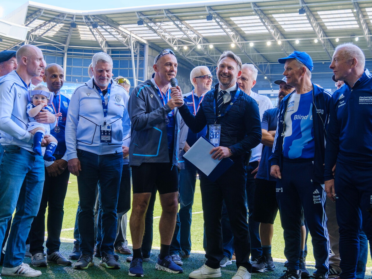 Paul Mardon and the cyclists being interview by Hursty pitch side.
