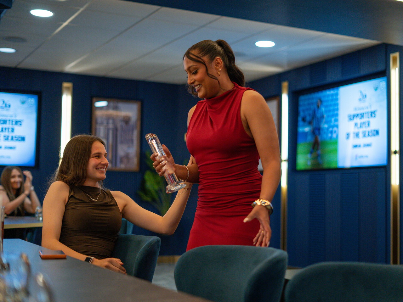 Simran Jhamat collecting the Supporters' Player of the Season award.