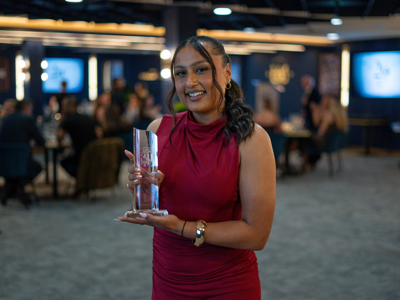 Simran Jhamat collecting the Supporters' Player of the Season award.