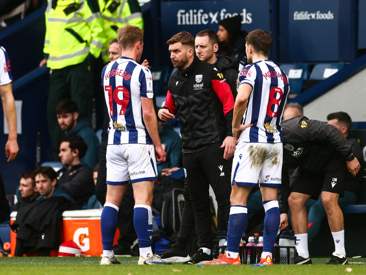 James Morrison chatting to Aune Heggebø and Jayson Molumby during a break in the game against Wrexham 