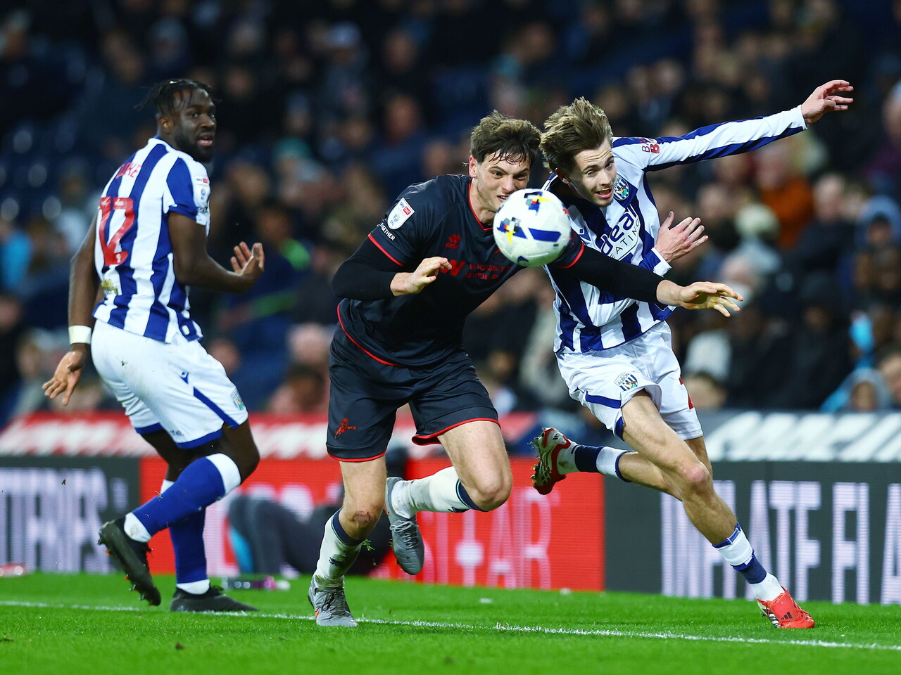 Isaac Price battling for the ball against a Millwall player 