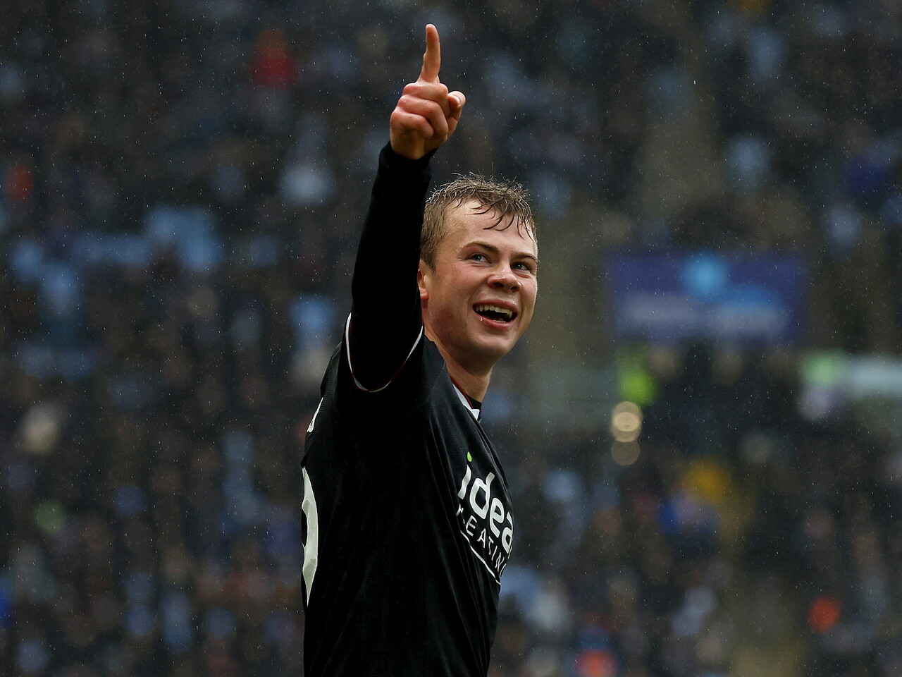 Aune Heggebø celebrates scoring against Coventry City at the CBS Arena in the black away kit 