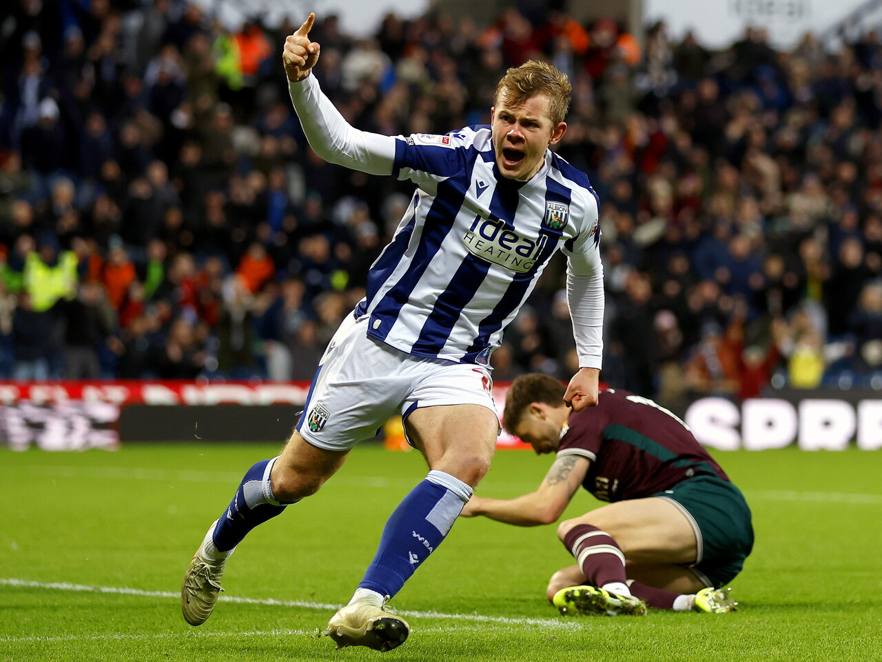 Aune Heggebø celebrates scoring against Swansea City at The Hawthorns in the home kit 
