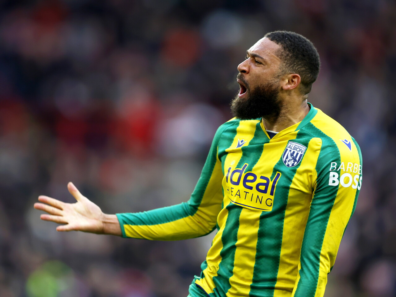 George Campbell celebrates scoring at Sheffield United in the green and yellow away kit 
