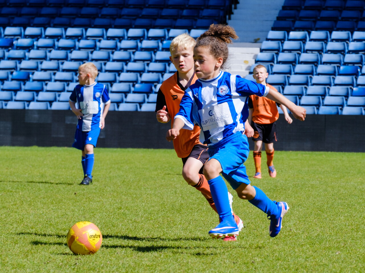 Worcester City player driving with the ball with a ST Kevin's defender chasing.