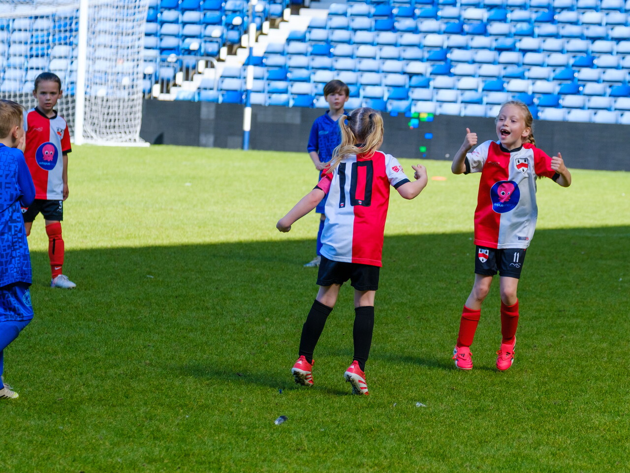 Two Old Wulfrunians Girls players celebrating a goal.