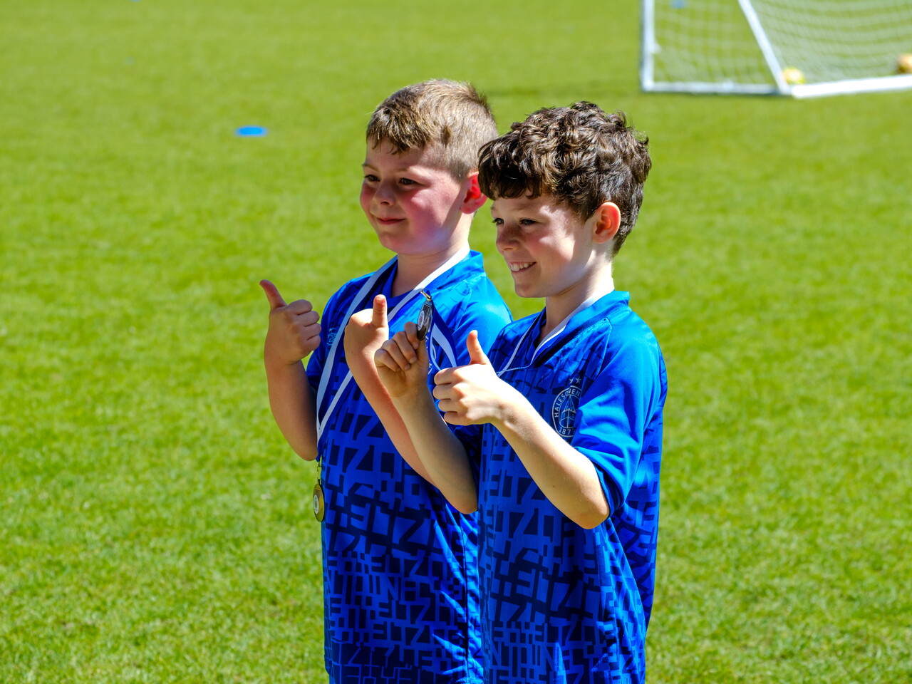 Two player's pitch side wit their thumbs.