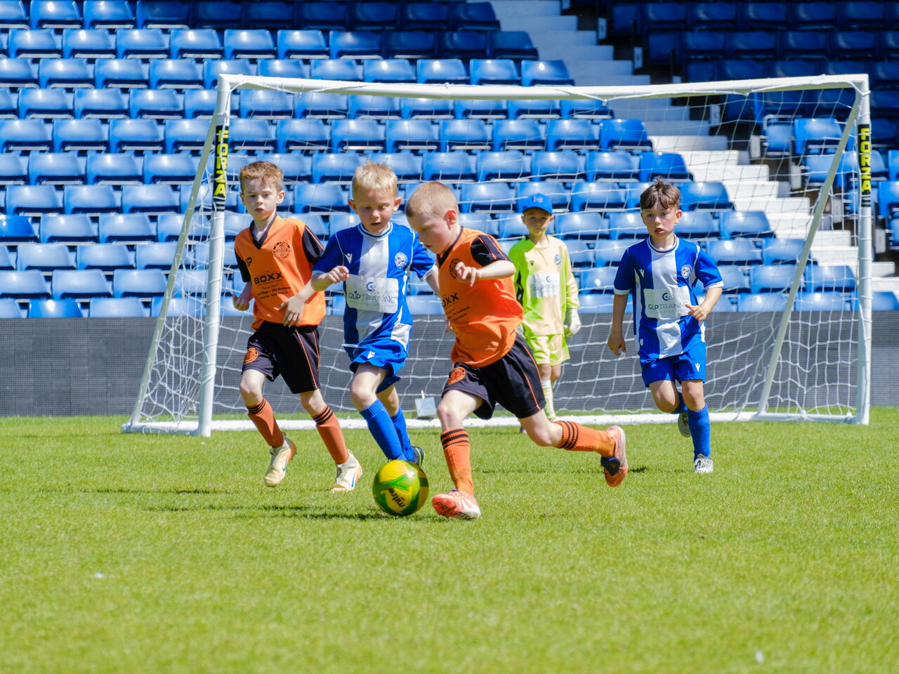 St. Kevin's FC & Worcester City players challenging for the ball.
