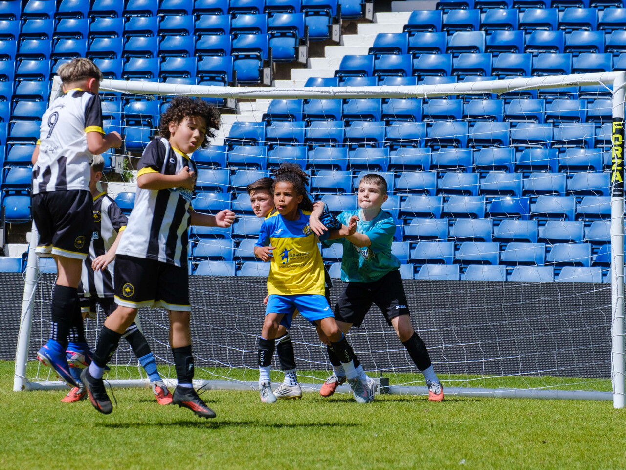 Players jumping to block a free kick kick with player in front of the keeper