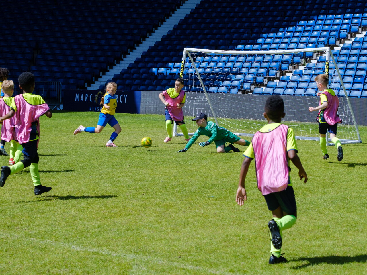 Keeper diving for the ball with players look to get the rebound.
