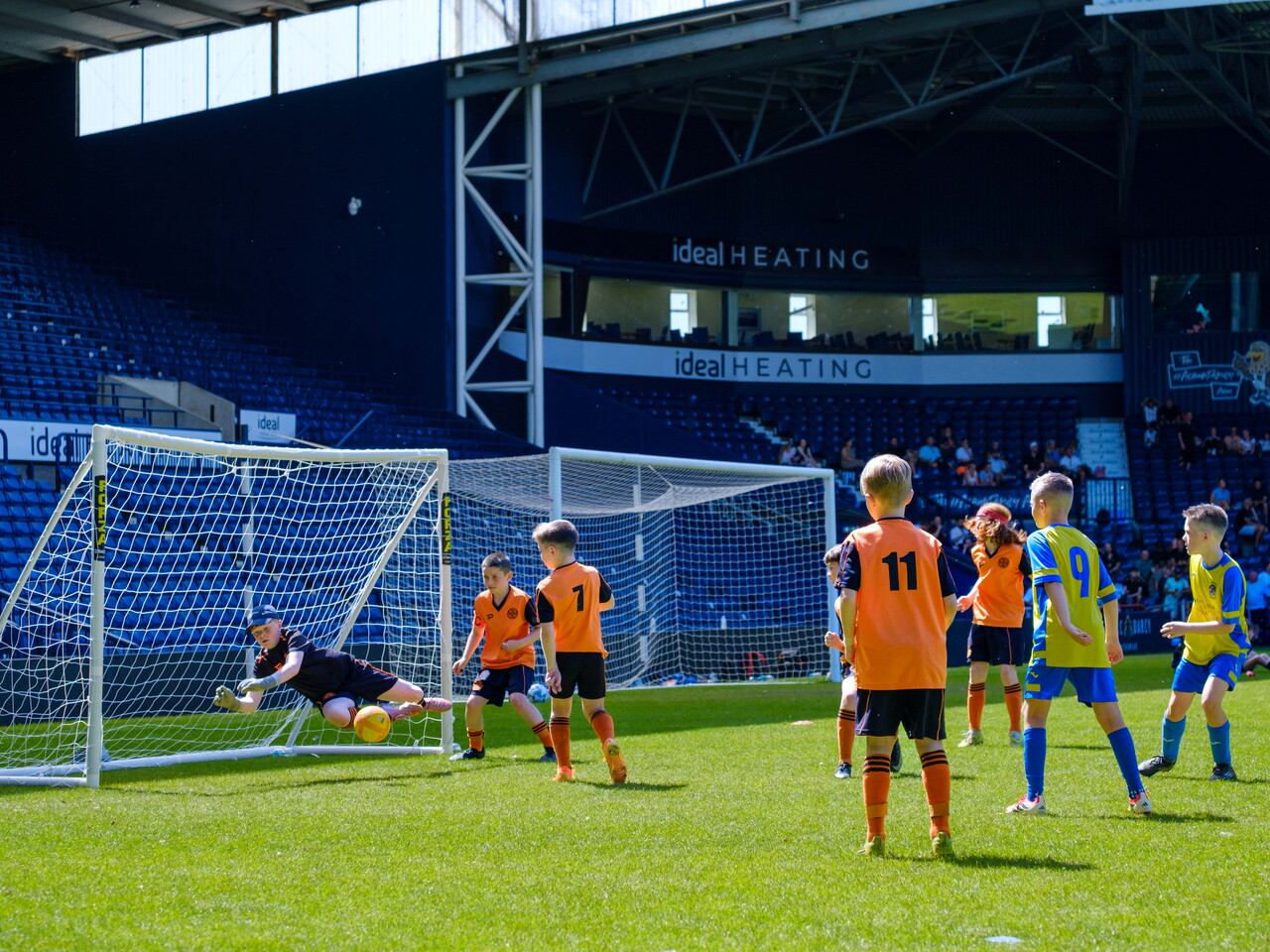 St. Kevin's FC keeper making a key save with players gathered.