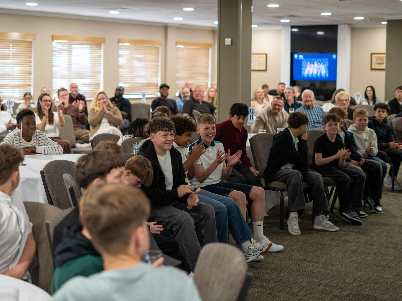 Wide shot of parents and players at MJPL Awards evening.