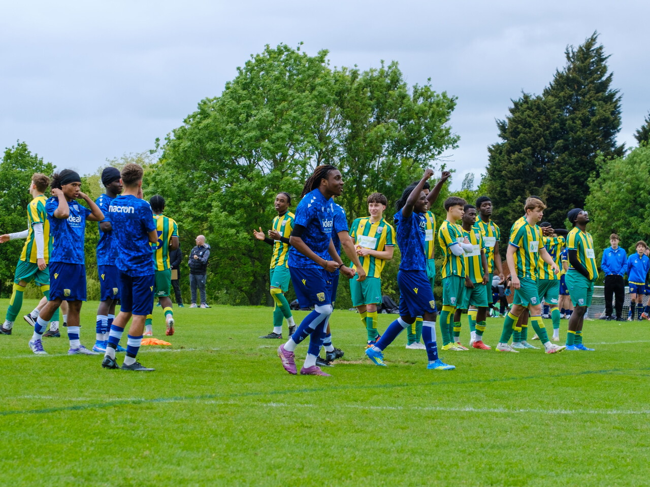 teams on the halfway line during penalty shoot-out