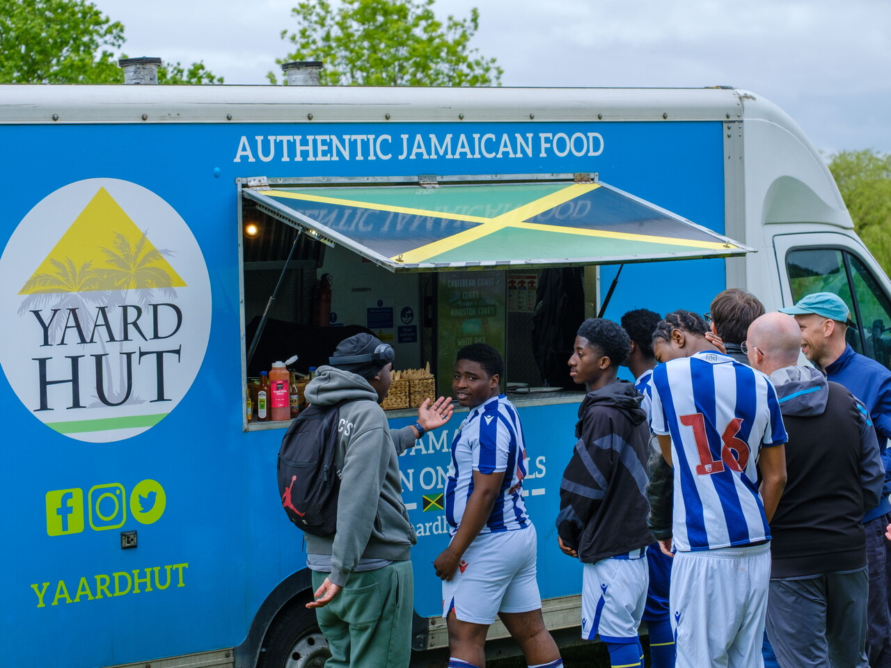 Players standing outside the Yaard Hut food truck.