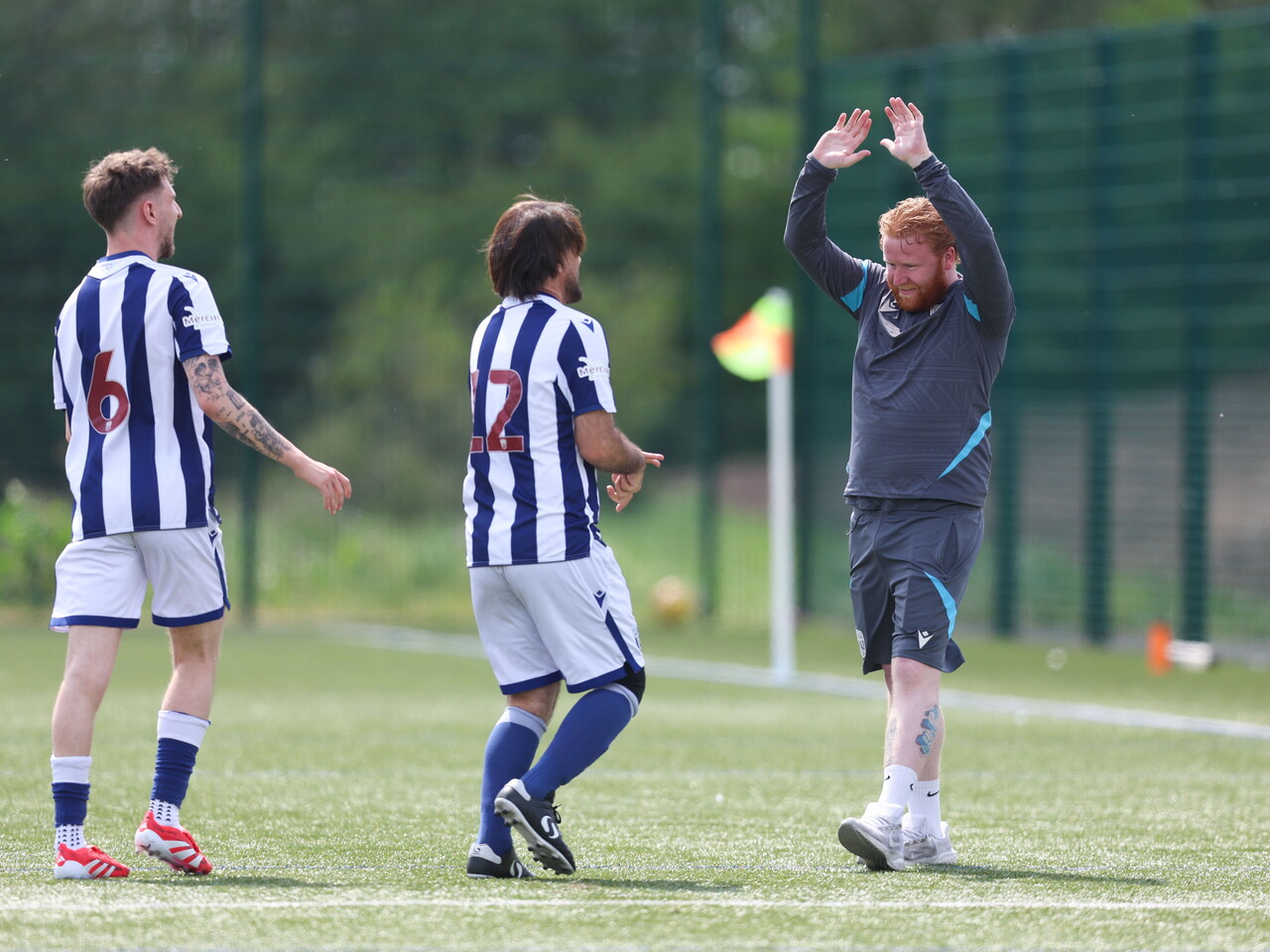 WBA coach giving a player a high-five.