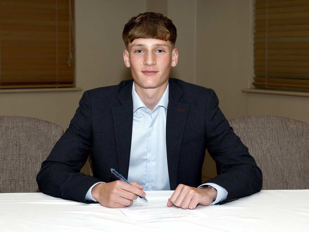 A photo of Albion youngster Archie Saeed signing his scholarship deal ahead of the 2026/27 campaign