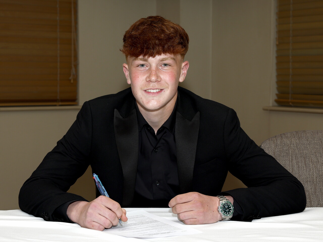 A photo of Albion youngster Archie Williams signing his scholarship deal ahead of the 2026/27 campaign