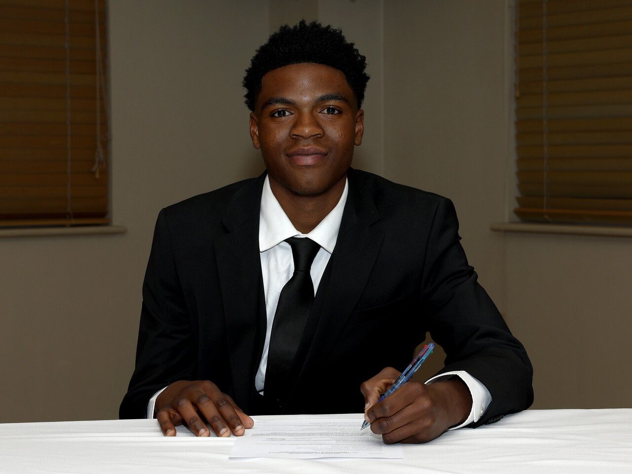 A photo of Albion youngster Dylan Nasibu signing his scholarship deal ahead of the 2026/27 campaign