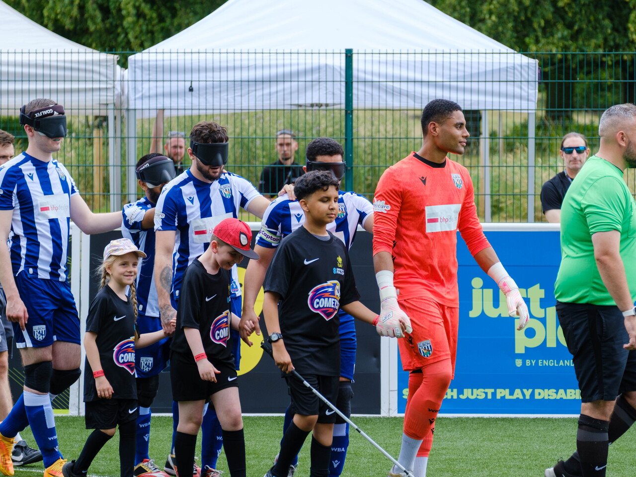 WBA Players walking out with mascots.