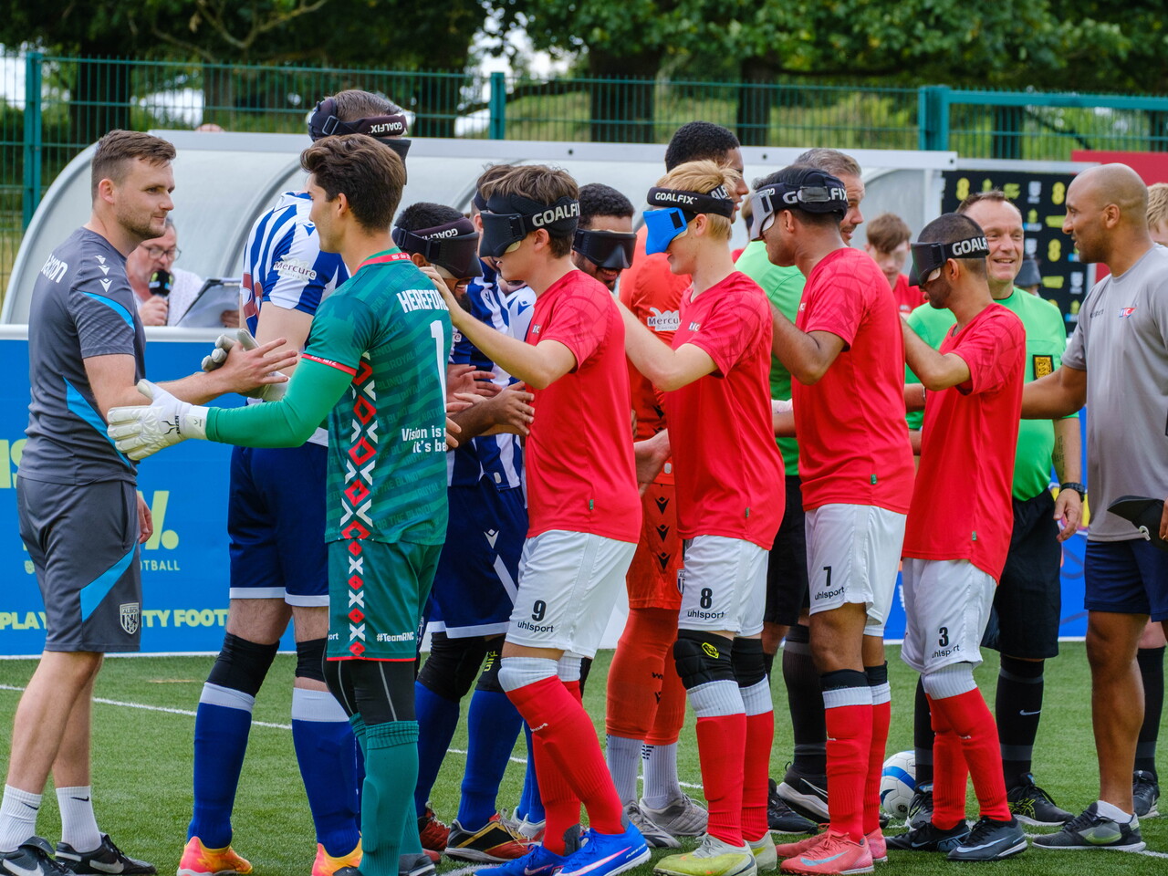 RNC players shaking hands with WBA Blind players.