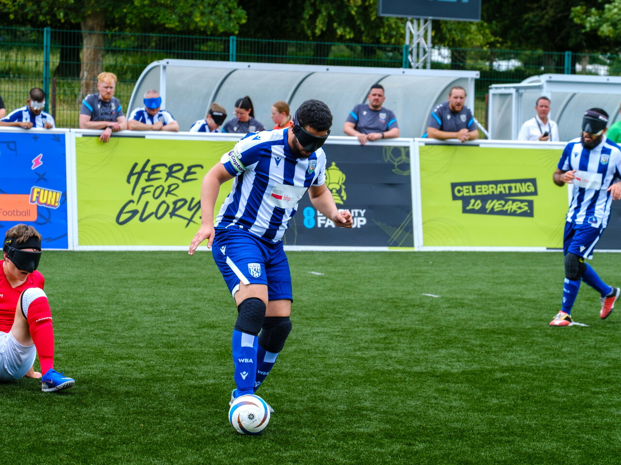 Mo controlling the ball with Eesa in the distance and a RNC player on the floor.