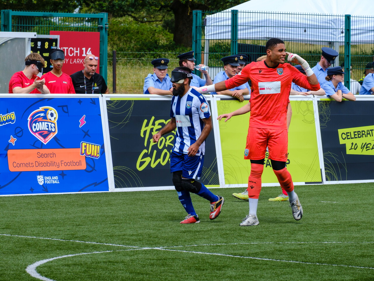 Owen Locke pointing at his head with a hand on Eesa shoulder as the set-up for the restart.