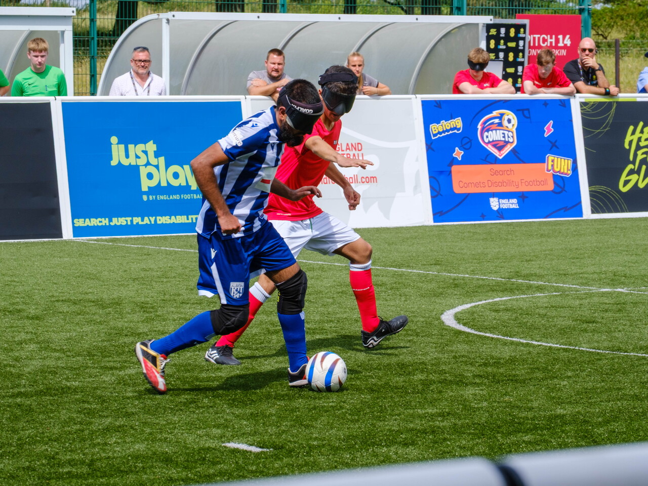 Eesa driving with the ball as a RNC players chases.
