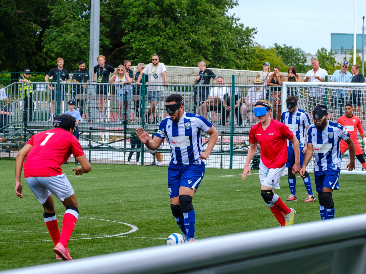 Mo Ahmed driving the ball with players chasing.