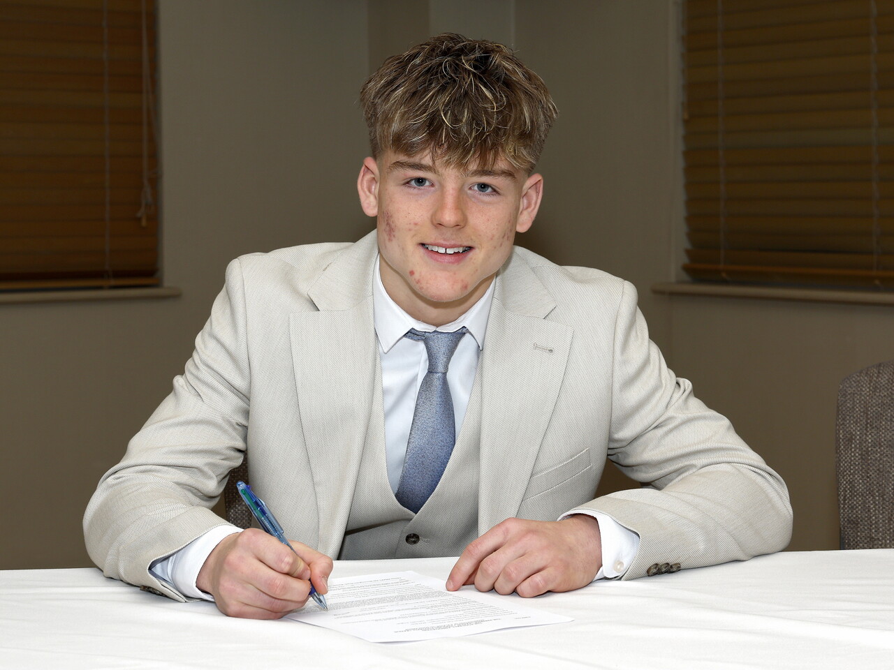 A photo of Albion youngster Ethan Smith signing his scholarship deal ahead of the 2026/27 campaign