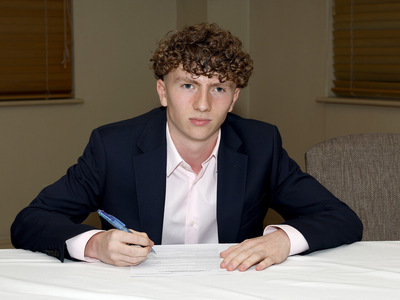 A photo of Albion youngster Frazer Billings signing his scholarship deal ahead of the 2026/27 campaign