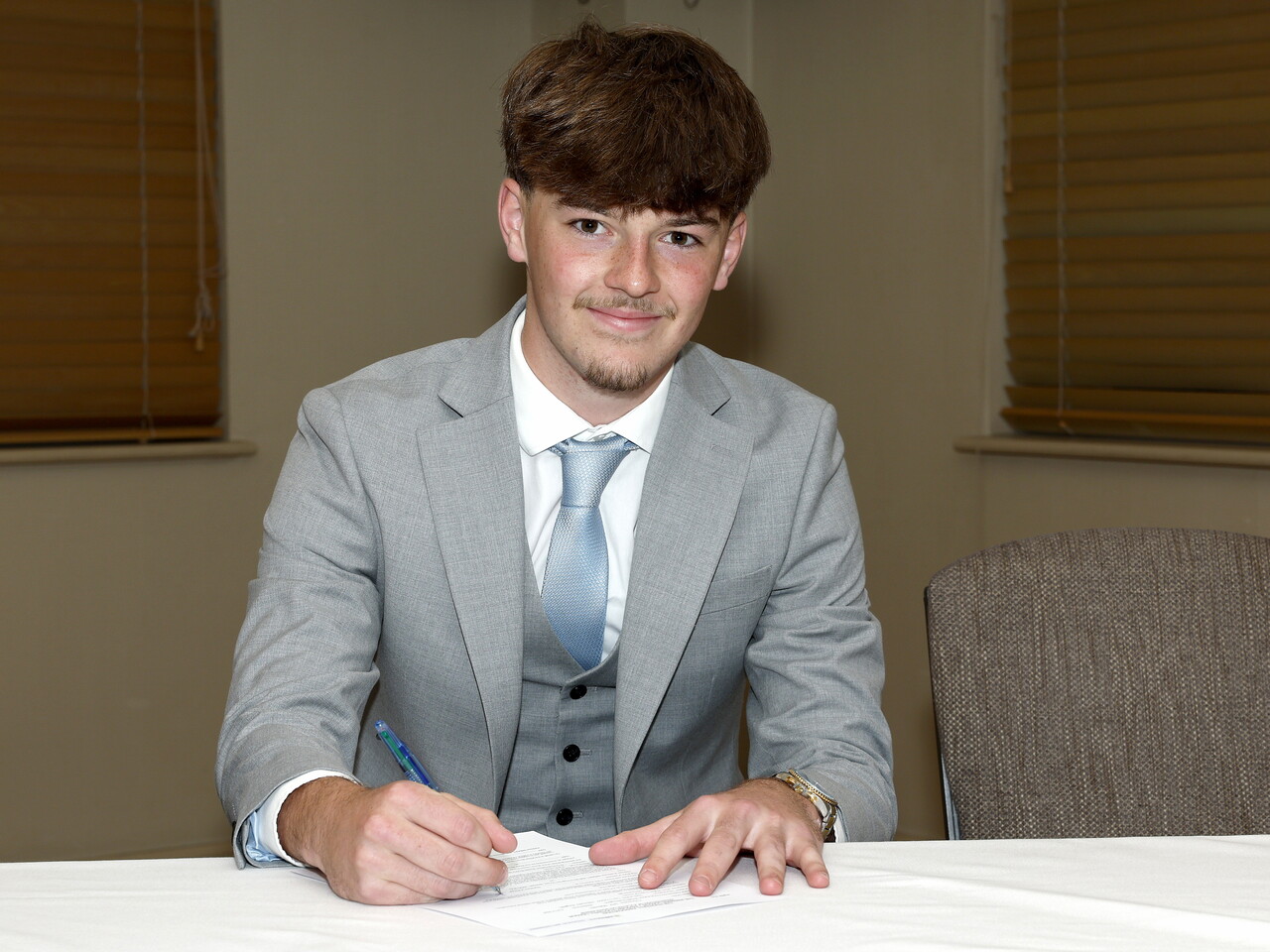 A photo of Albion youngster Jack Lines signing his scholarship deal ahead of the 2026/27 campaign