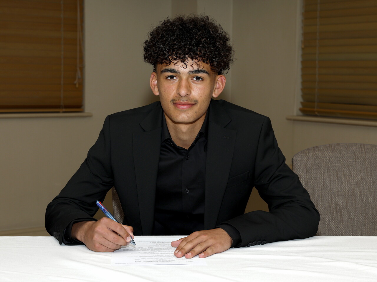 A photo of Albion youngster James Bythell signing his scholarship deal ahead of the 2026/27 campaign