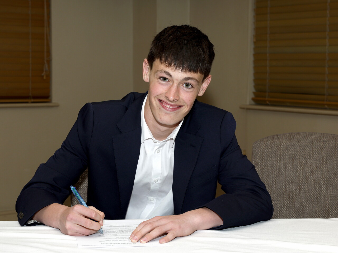 A photo of Albion youngster Lewis Shead signing his scholarship deal ahead of the 2026/27 campaign