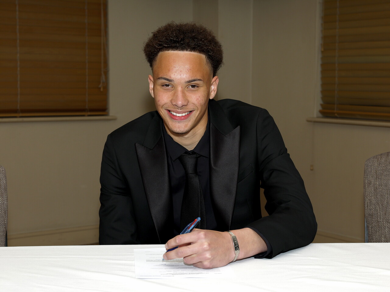 A photo of Albion youngster Reuben Saa signing his scholarship deal ahead of the 2026/27 campaign