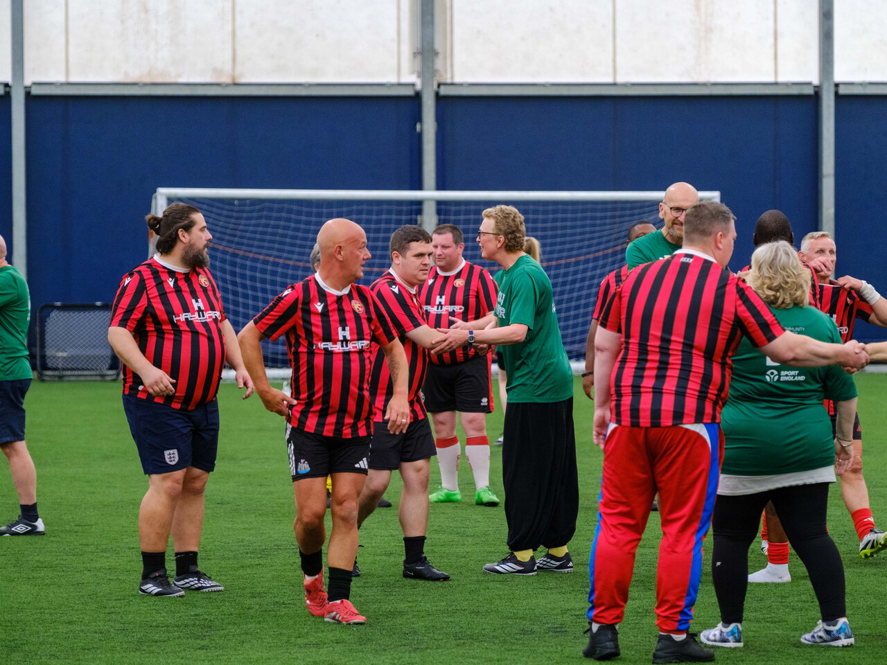 Big C Tackling Cancer and Beat the Block shaking hands after the game.