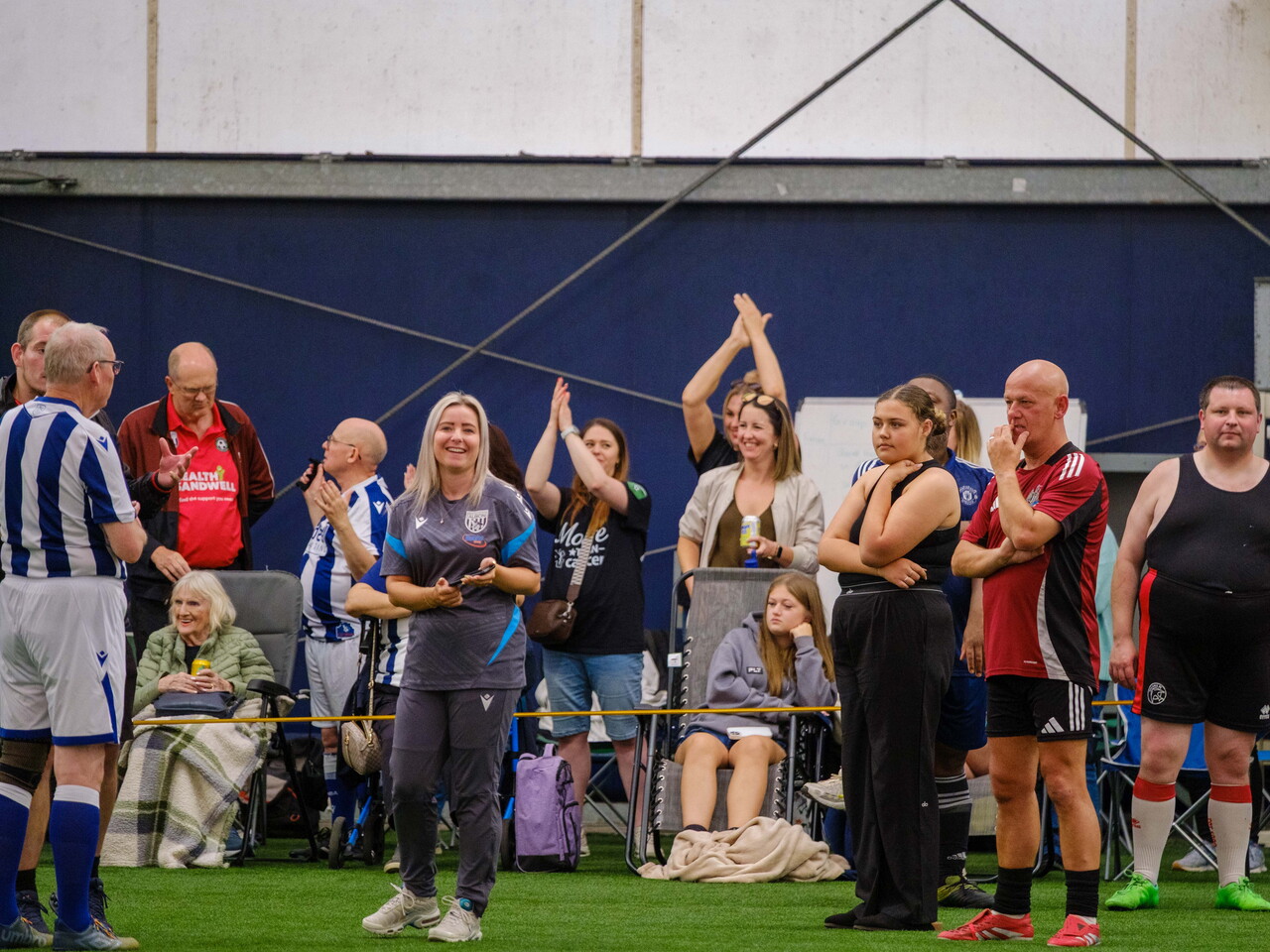 Spectators celebrating on the sideline.