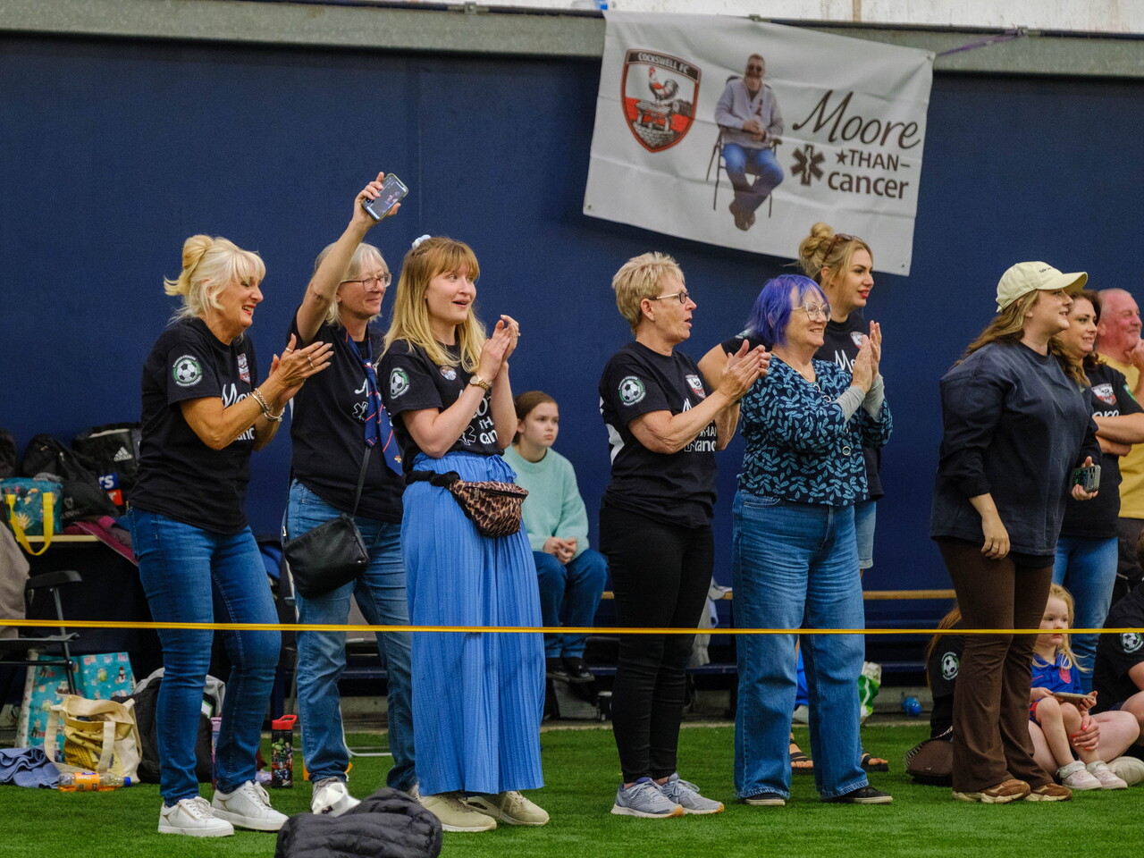 Moore than Cancer spectators cheering on the sideline.